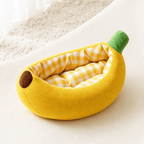 Angled view of banana-shaped pet bed on a clean background