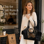 Black mesh pet carrier tote carried over a shoulder outside a cafe.