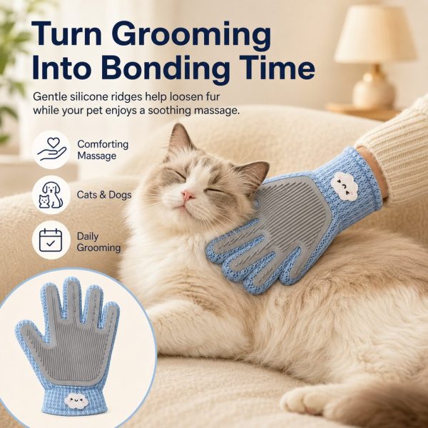 Blue dual sided pet grooming glove massaging a resting cat's cheek during grooming.