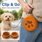 Collapsible double pet travel bowl folded in an orange paw case clipped to a belt loop.