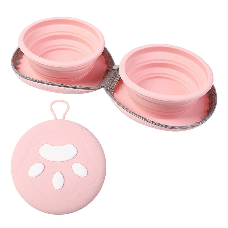 Collapsible double pet travel bowl in pink with both bowls open beside the closed paw case.