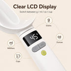 Digital pet food measuring spoon closeup of the LCD display and unit selection buttons.