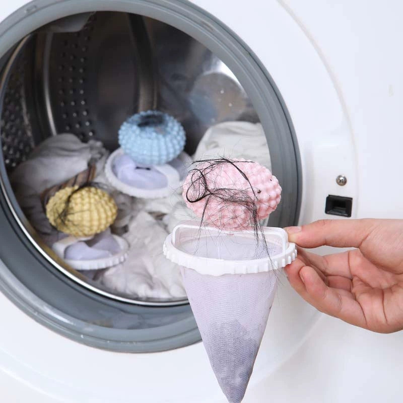 Floating laundry lint and pet hair catcher held beside an open washer with hair caught in the mesh.