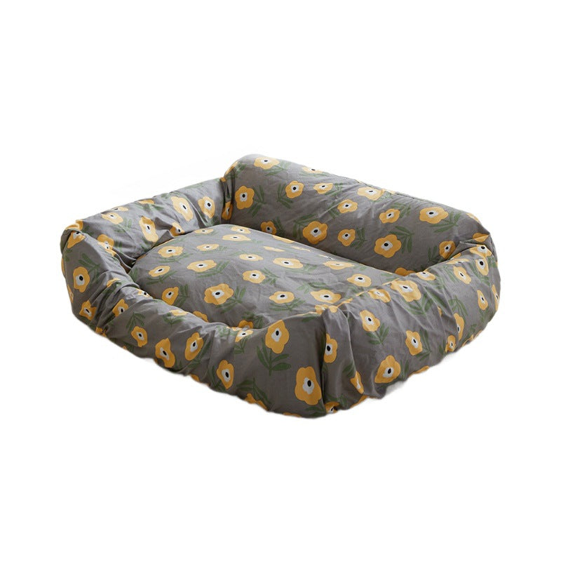 Floral replacement dog bed cover fitted on a rectangular bolster bed against a white background.
