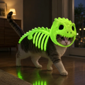 Glow-in-the-dark dinosaur pet costume glowing on a cat at night