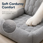 Gray corduroy dog car seat bed closeup showing a dog's paw on the corduroy cushion.