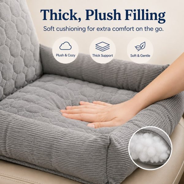 Gray corduroy dog car seat bed with a hand pressing the padded cushion and a filling inset.