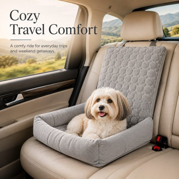 Gray corduroy dog car seat bed with a small brown dog resting during a countryside drive.