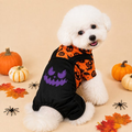 Halloween dog jumpsuit with a purple monster emblem worn by a white dog.