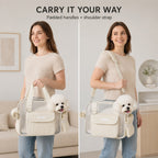 Mesh pet carrier tote in cream demonstrating hand and shoulder carrying with a small dog.