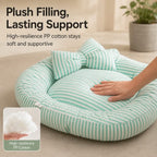 Mint striped bolster pet bed with a hand pressing the cushion and a filling closeup.