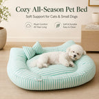 Mint striped bolster pet bed with a white dog curled up in a living room.
