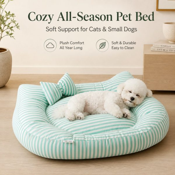 Mint striped bolster pet bed with a white dog curled up in a living room.