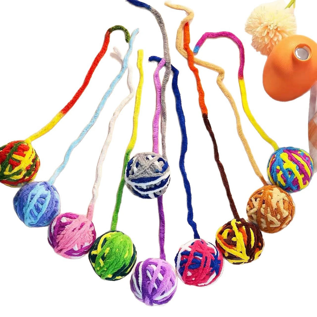 Assorted mixed-color cat ball toys on a clean background
