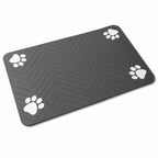 Paw print pet feeding mat in dark gray displayed alone against a white background.