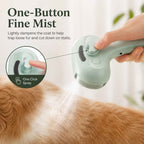 Pet spray grooming brush in mint releasing mist over a cat's coat.