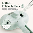 Pet spray grooming brush in mint with water being added through the refill port.